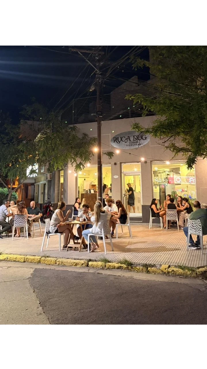 Amigas tomando helado en la vereda de la heladería